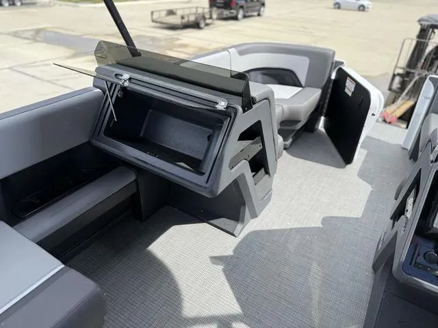 Slide: The Image of 2024 Manitou Cruise 22 Max Switchback V-Toon interior with seating and storage compartments. - 12
