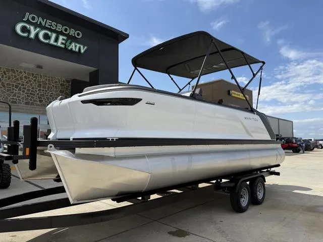 Slide: The Image of 2024 Manitou Cruise 22 Max Switchback V-Toon pontoon boat with canopy on a concrete surface. - 3