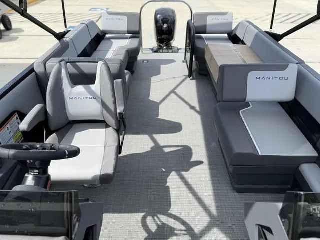 Slide: The Image of 2024 Manitou Cruise 22 Max Switchback V-Toon boat dashboard and steering wheel. - 7