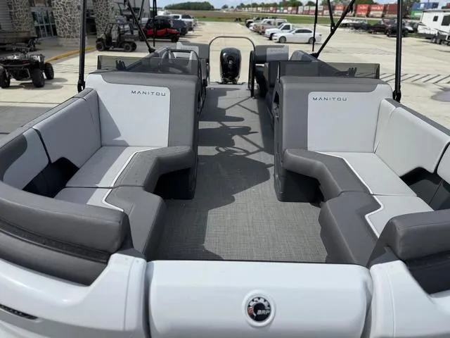 Slide: The Image of 2024 Manitou Cruise 22 Max Switchback V-Toon pontoon boat interior with gray seating. - 9