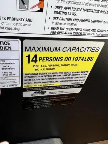 Slide: The Image of 2024 Manitou Explore 26 Switchback Single Engine V-Toon capacity label: 14 persons or 1974 lbs. - 18