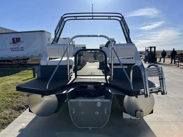 Slide: The Image of 2024 Manitou Explore 26 Switchback Single Engine V-Toon boat, rear view at dock. - 7