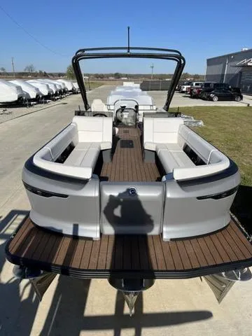 Slide: The Image of 2024 Manitou Explore 26 Switchback Single Engine V-Toon pontoon boat, docked, rear view. - 9
