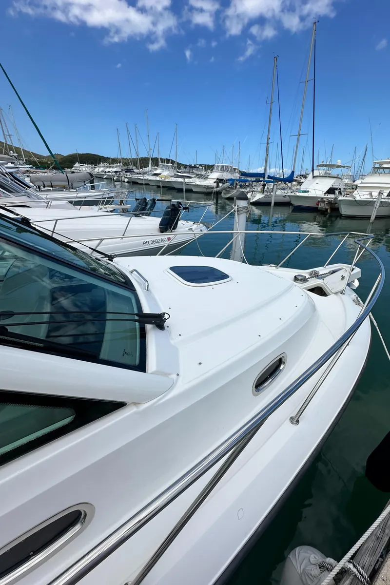 Slide: The Image of 2015 Boston Whaler 345 Conquest docked in a marina with other boats. - 12