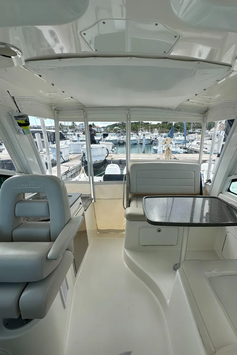 Slide: The Image of Interior of a 2015 Boston Whaler 345 Conquest boat with seating and table. - 5