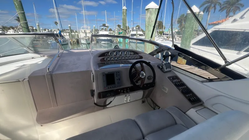 Slide: The Image of Cockpit of 2003 Regal Commodore 3260 yacht with steering wheel and navigation controls. - 12