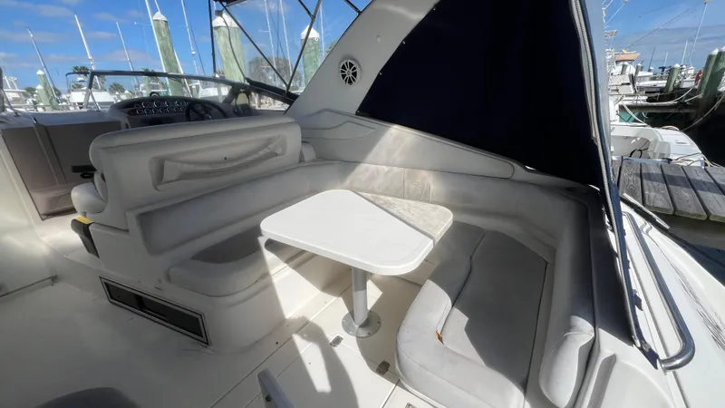 Slide: The Image of 2003 Regal Commodore 3260 boat interior with seating and table, docked at marina. - 18
