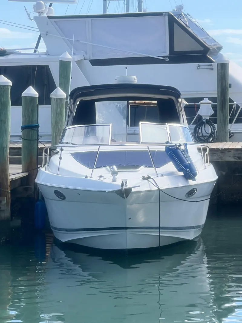 Slide: The Image of 2003 Regal Commodore 3260 boat docked at marina, front view. - 2