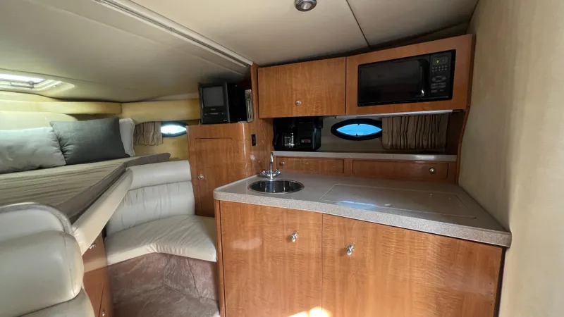 Slide: The Image of 2003 Regal Commodore 3260 yacht interior with kitchenette, bed, and seating area. - 20
