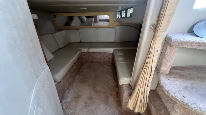 Slide: The Image of 2003 Regal Commodore 3260 interior with beige seating and carpeted steps. - 25