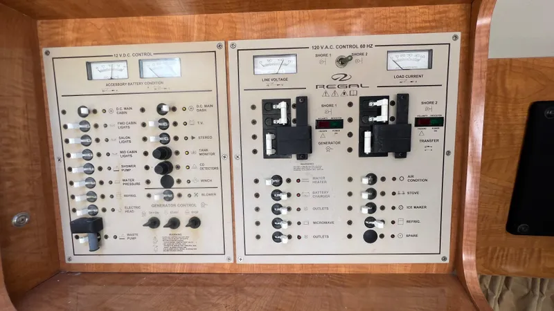 Slide: The Image of Control panel of a 2003 Regal Commodore 3260 boat with various switches and gauges. - 28