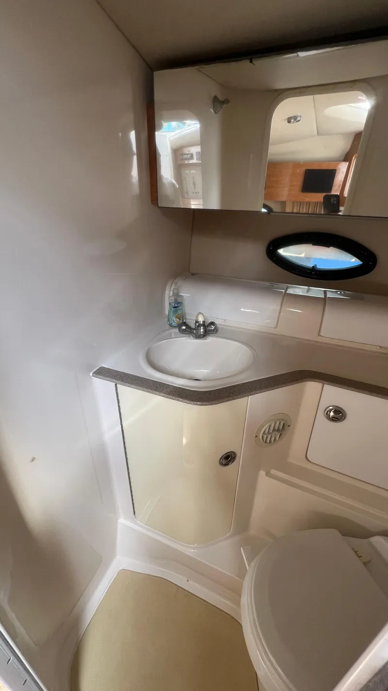 Slide: The Image of 2003 Regal Commodore 3260 bathroom with sink, mirror, and storage cabinets. - 29