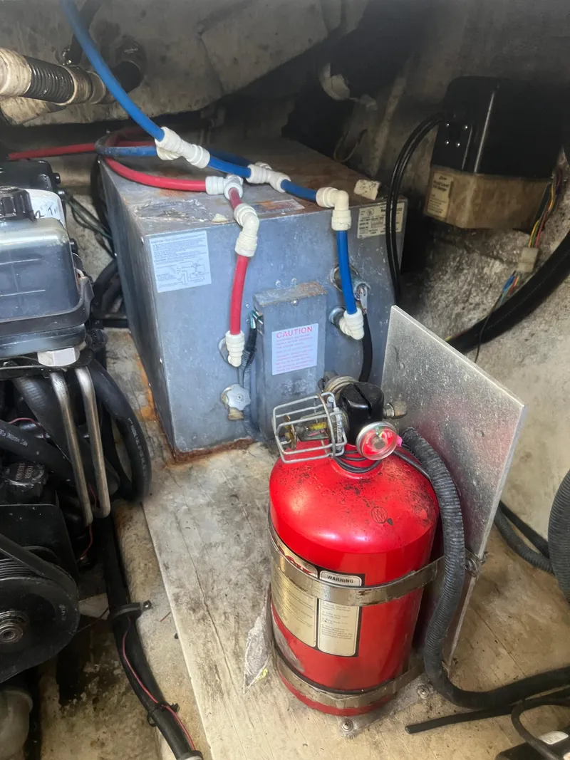 Slide: The Image of Engine compartment of 2003 Regal Commodore 3260 with fire extinguisher and wiring. - 35