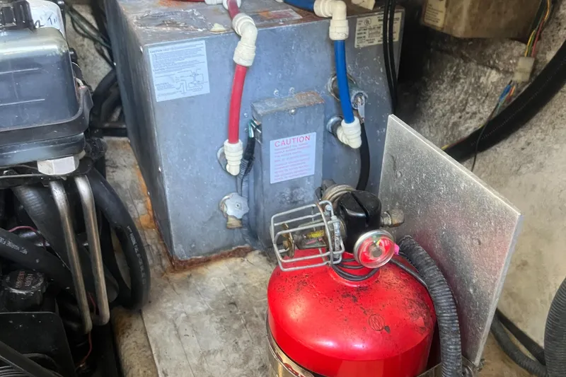 Slide: The Image of Engine compartment of 2003 Regal Commodore 3260 with fire extinguisher and wiring. - 36