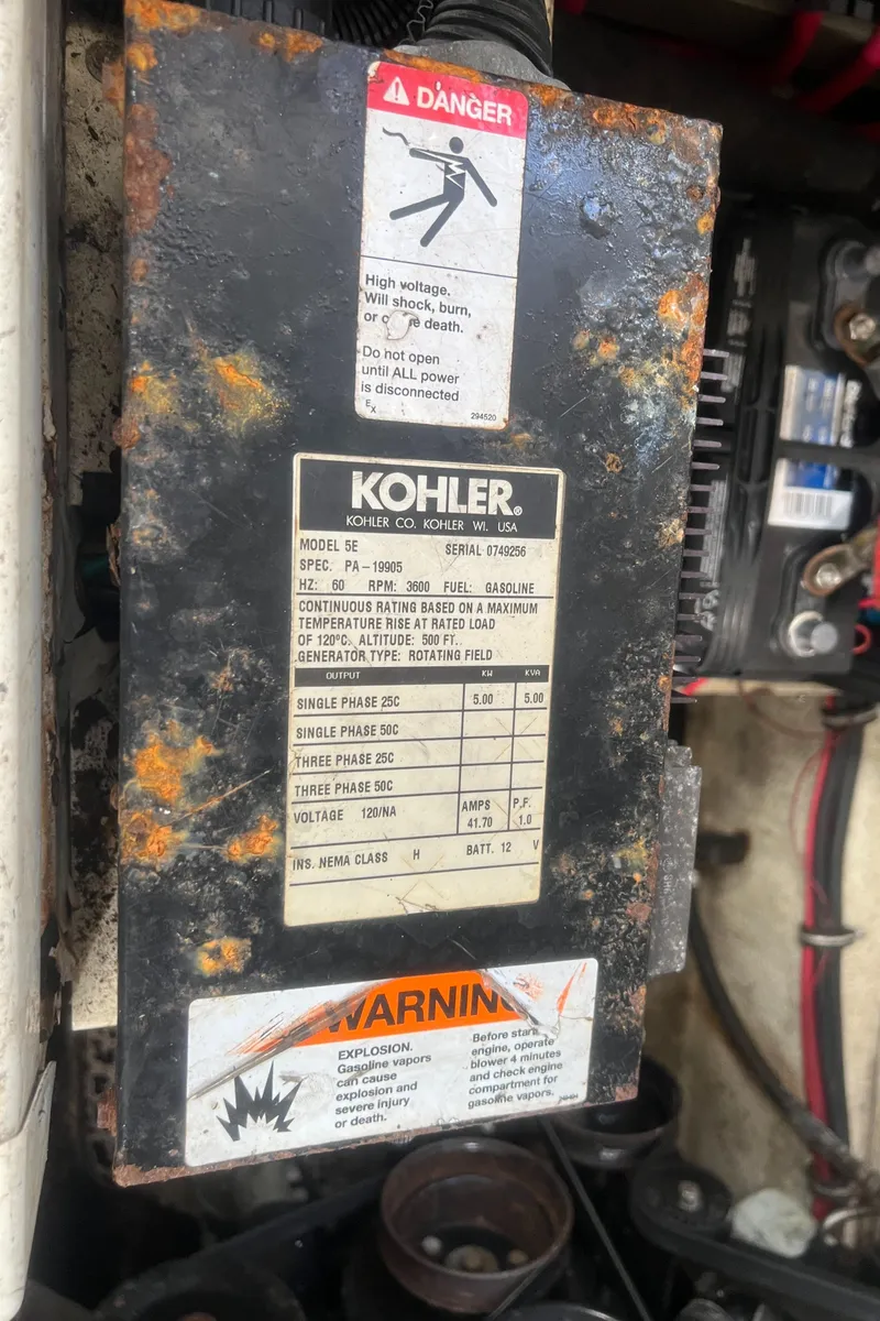 Slide: The Image of Rusty Kohler generator panel with warning labels on a 2003 Regal Commodore 3260 boat. - 37