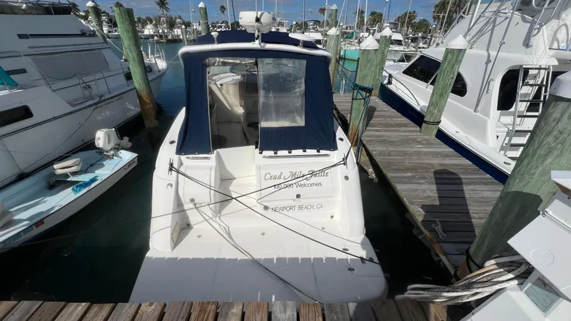 Slide: The Image of 2003 Regal Commodore 3260 yacht docked at a marina, surrounded by other boats. - 4