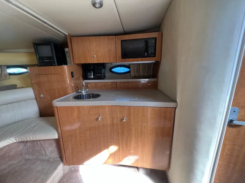 Slide: The Image of 2003 Regal Commodore 3260 yacht interior with kitchenette, microwave, and sink. - 43