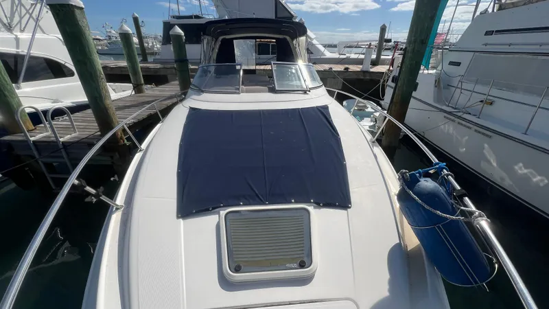 Slide: The Image of 2003 Regal Commodore 3260 yacht docked at marina, featuring sleek design and spacious deck. - 5