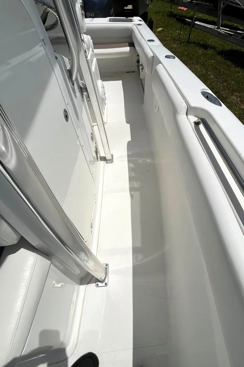 Slide: The Image of 2012 Sea Hunt Gamefish 25 boat interior, white deck and seating area. - 21