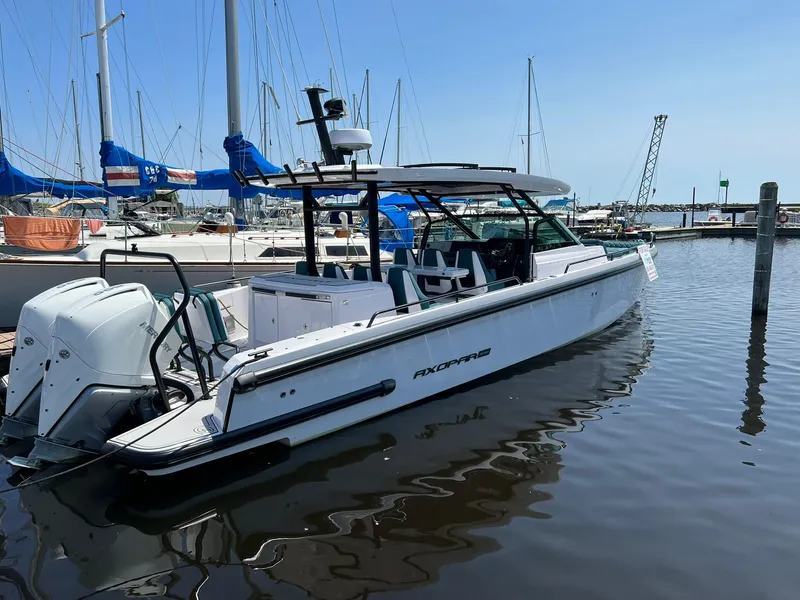 Slide: The Image of 2022 Axopar 37 Sun Top boat docked in a marina. - 1