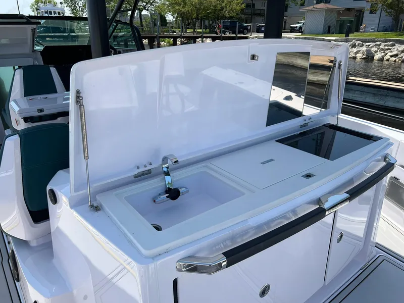 Slide: The Image of 2022 Axopar 37 Sun Top boat with onboard sink and storage. - 11