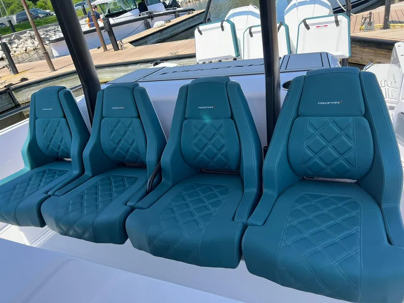 Slide: The Image of 2022 Axopar 37 Sun Top boat with teal diamond-stitched seats. - 13