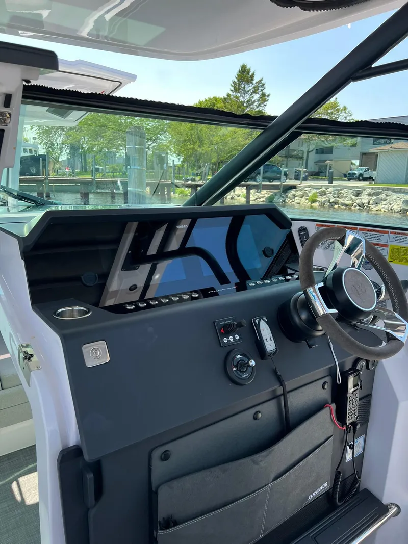 Slide: The Image of 2022 Axopar 37 Sun Top helm station with modern navigation equipment. - 14