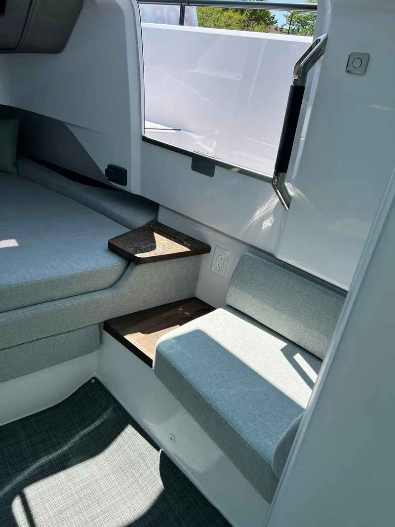 Slide: The Image of 2022 Axopar 37 Sun Top interior cabin with seating and storage. - 21