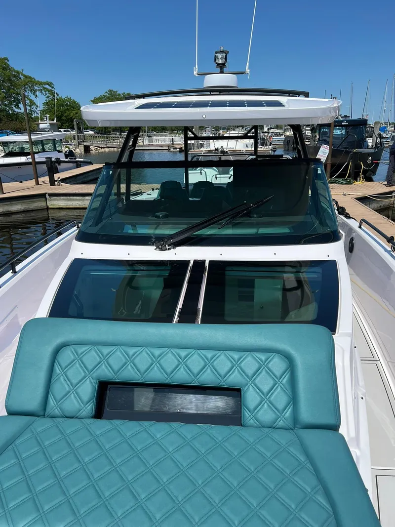 Slide: The Image of 2022 Axopar 37 Sun Top boat docked at marina, front view. - 28