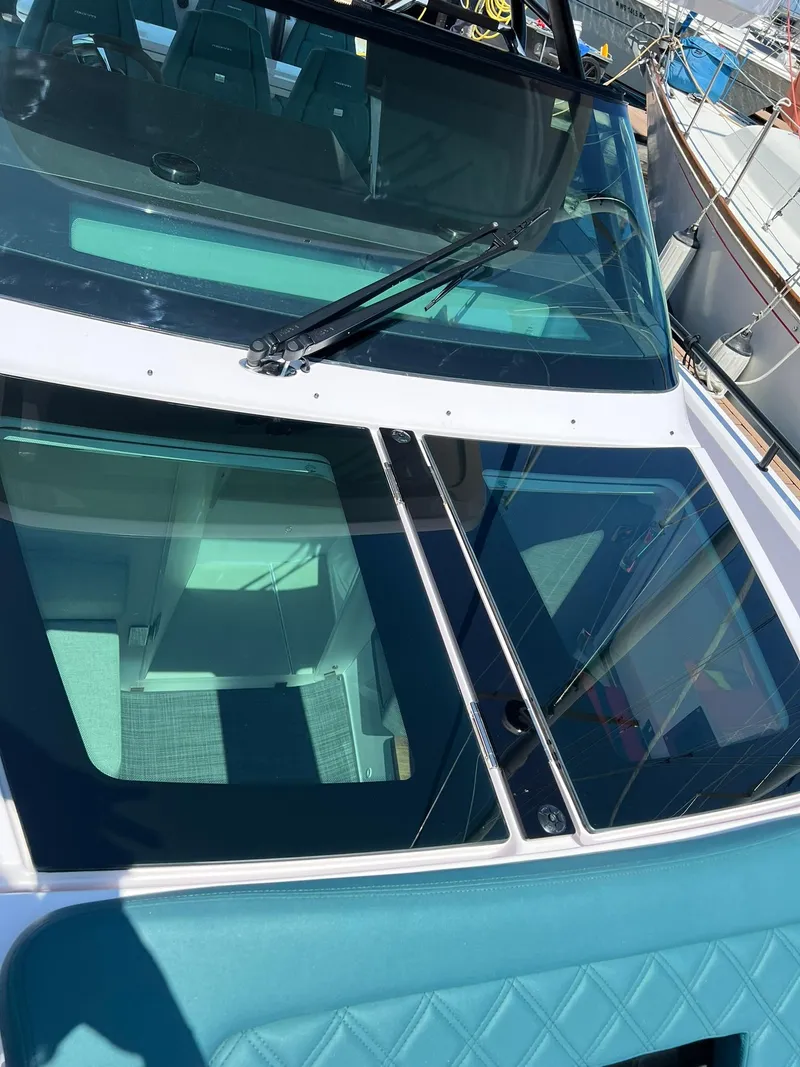 Slide: The Image of 2022 Axopar 37 Sun Top boat with teal upholstery and glass roof. - 29
