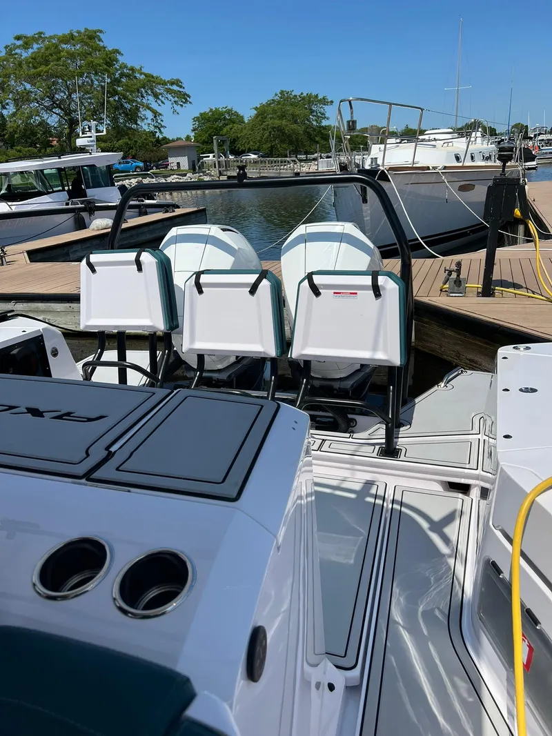 Slide: The Image of 2022 Axopar 37 Sun Top boat docked at a marina, featuring sleek seating and modern design. - 35