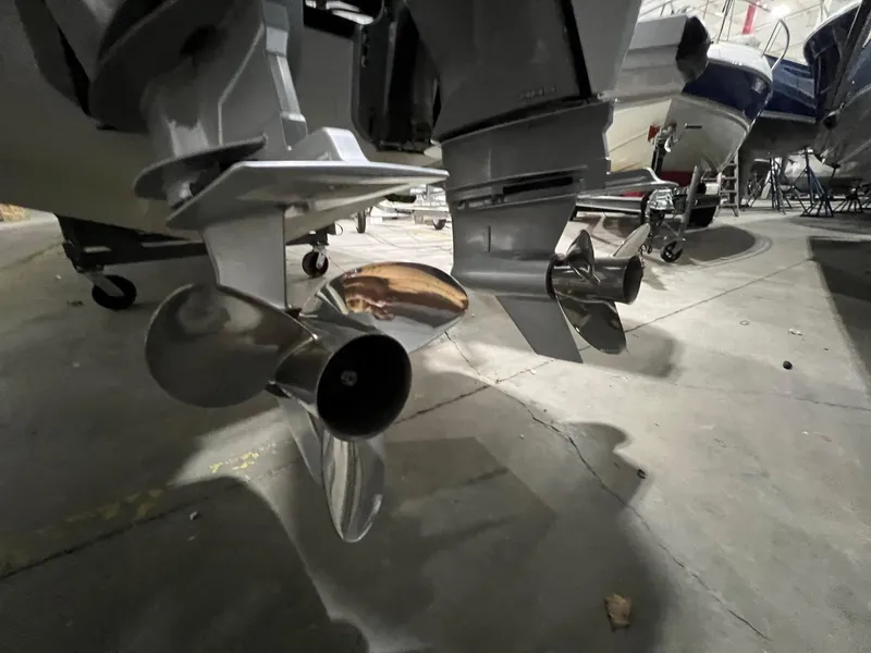 Slide: The Image of Close-up of 2022 Axopar 37 Sun Top boat propellers in a storage facility. - 37