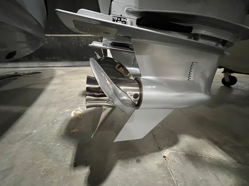 Slide: The Image of Close-up of a 2022 Axopar 37 Sun Top boat propeller in a garage. - 38