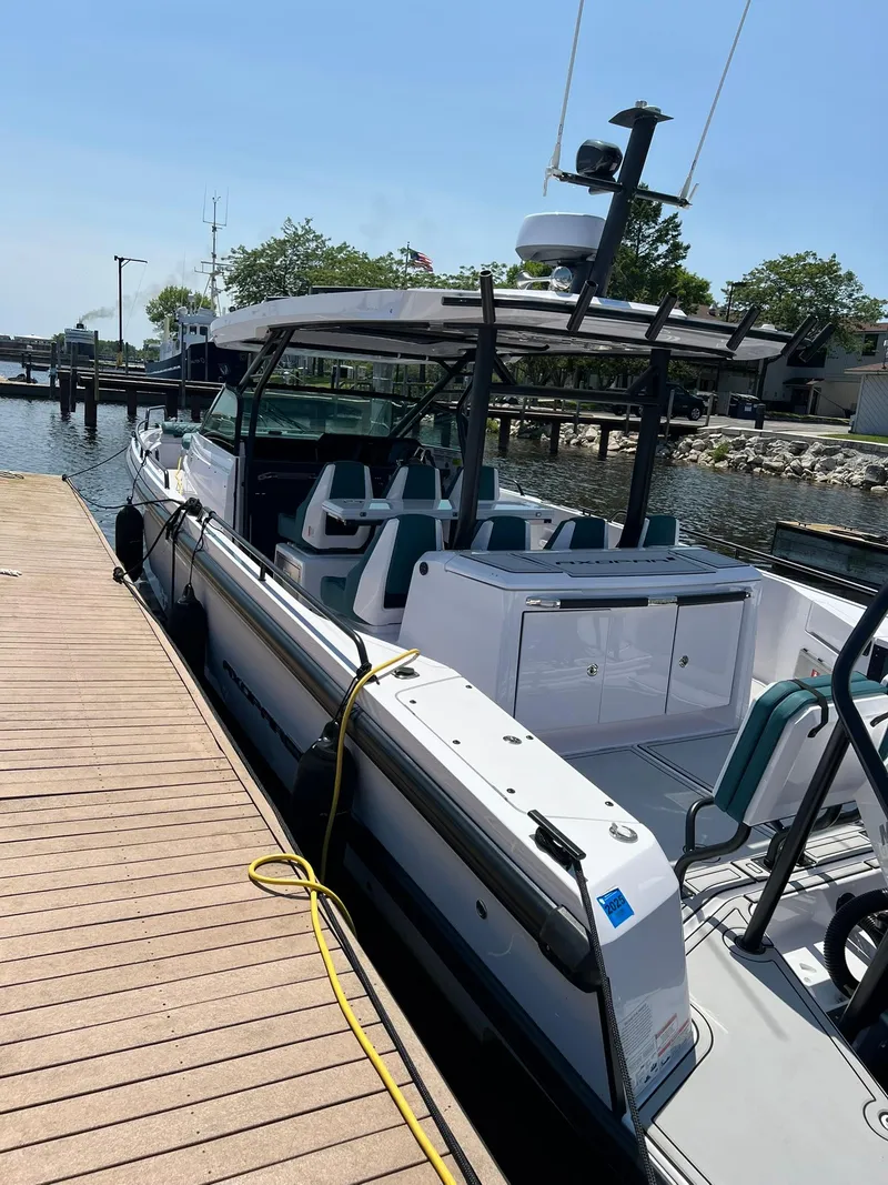 Slide: The Image of 2022 Axopar 37 Sun Top docked at a marina on a sunny day. - 6