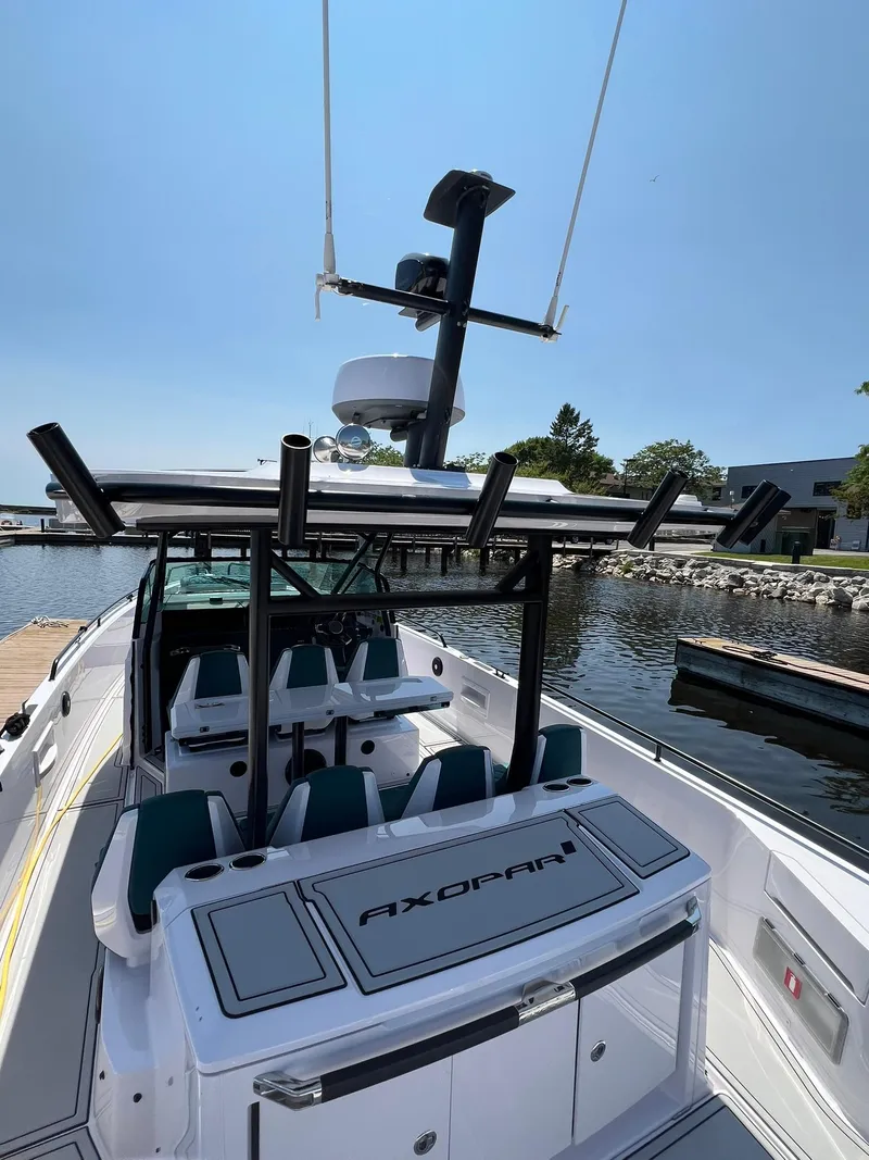 Slide: The Image of 2022 Axopar 37 Sun Top boat docked at a marina. - 7