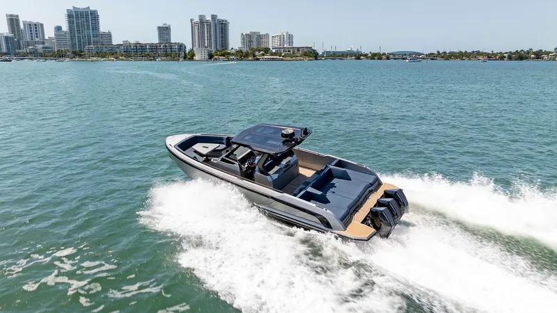 Slide: The Image of 2021 Vanquish Yachts VQ40 cruising on water near city skyline. - 17
