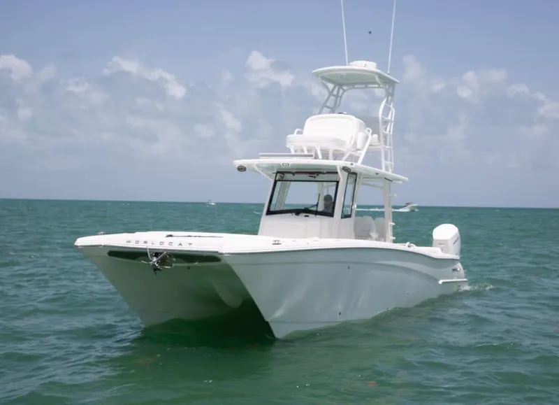 The Image of 2022 World Cat 400 CC-X boat on water at sunset, showcasing sleek design. - 0