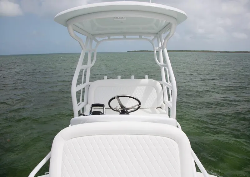 Slide: The Image of 2022 World Cat 400CC-X boat with dual outboard engines, spacious deck, and advanced helm station. - 12