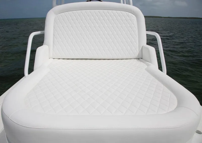 Slide: The Image of 2022 World Cat 400CC-X boat helm with white seating and steering wheel. - 15