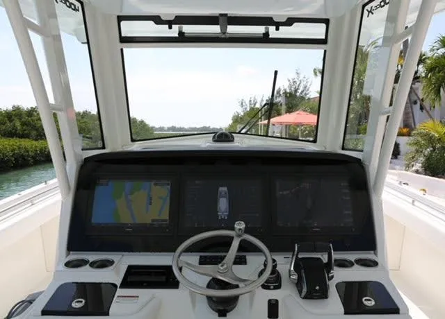 Slide: The Image of 2022 World Cat 400CC-X boat helm with steering wheel and control panel. - 17