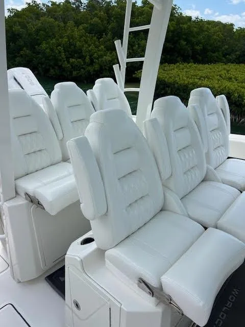 Slide: The Image of 2022 World Cat 400 CC-X boat deck, spacious seating, and sleek design on water. - 20