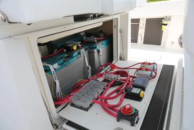 Slide: The Image of 2022 World Cat 400CC-X boat storage compartment with open lid and organized gear. - 22