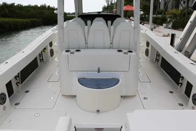 Slide: The Image of 2022 World Cat 400 CC-X boat interior with luxurious white seating on open water. - 25