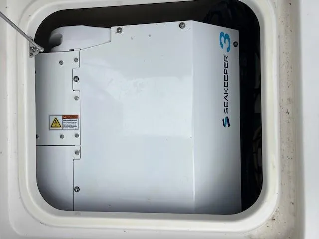 Slide: The Image of Battery compartment of 2022 World Cat 400CC-X boat with wiring and electrical components. - 28