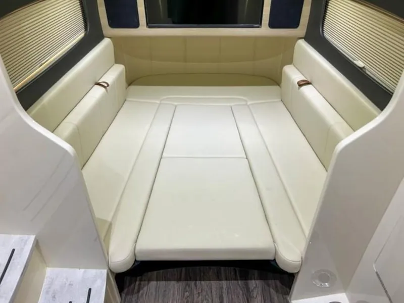 Slide: The Image of 2023 Scout 400 LXF cabin interior with beige seating and wood flooring. - 17
