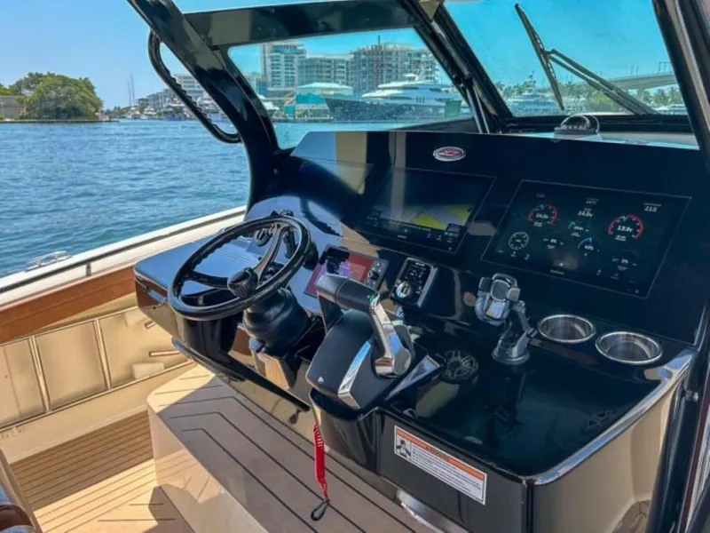 Slide: The Image of 2023 Scout 400 LXF boat helm with modern controls and waterfront view. - 23
