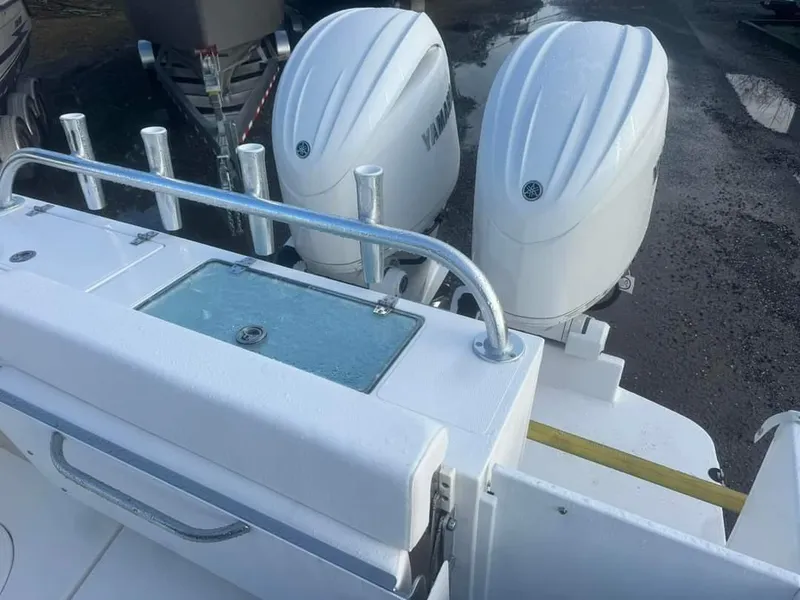 Slide: The Image of 2024 NorthCoast 255 Cabin boat with dual outboard engines and rod holders. - 13