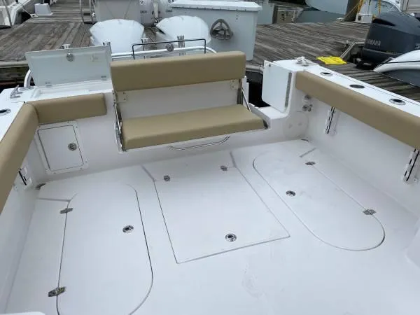 Slide: The Image of 2024 NorthCoast 255 Cabin boat with spacious deck and foldable seating. - 2