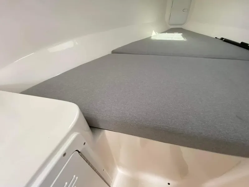 Slide: The Image of 2024 NorthCoast 255 Cabin interior with grey cushioned seating. - 21