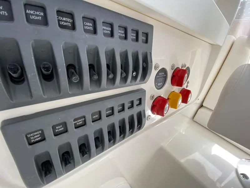 Slide: The Image of Control panel of a 2024 NorthCoast 255 Cabin boat with labeled switches and buttons. - 22